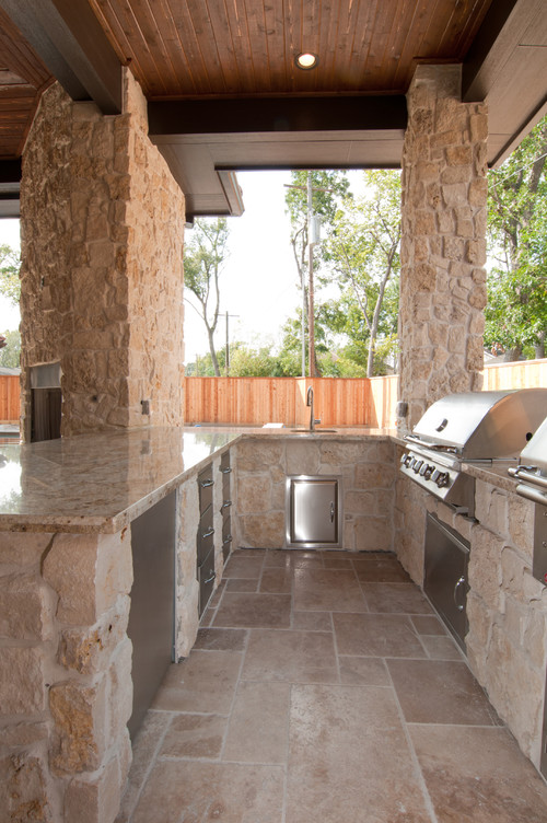 Polished Astoria Granite Countertop with Stainless Steel Base Cabinets and Natural Slate Counter Base, Stainless Steel Grill and Stainless Steel Brick Oven , Travertine flooring, Wooden Ceiling with Sun Tube